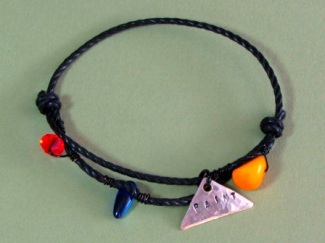 Bracelet - Paint, waxed black cotton cord, Picasso Jasper, Swarovski crystal, glass and hand stamped tag.
